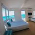 Brisa Marina Beach Resort powered by Cocotel in Morong, beachfront room with ocean-view windows and three beds