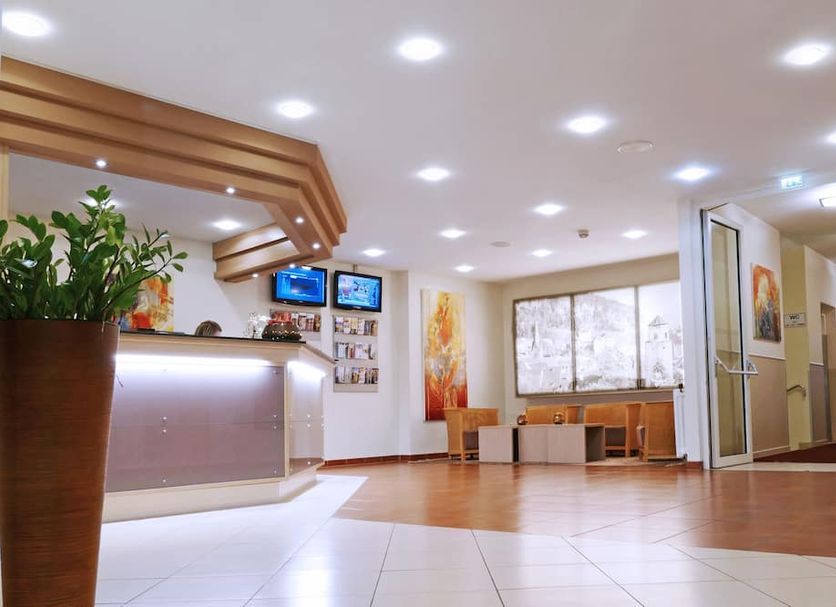Central Hotel Löwen in Feldkirch lobby with front desk, seating area and large windows