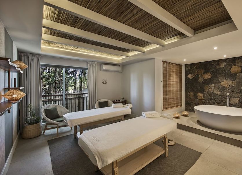 Preskil Island Resort Mahébourg spa treatment room with massage beds and freestanding bathtub