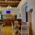 Dona Elvira Boutique Hotel in Santo Domingo dining room with wood bar, tiled floor and chandelier