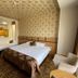 Sor Hotel Eskisehir guest room with two beds, patterned wallpaper and seating in Eskişehir