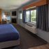 Black Beach Inn by GrandStay in Silver Bay guest room with king bed, fireplace, desk and lake-view window