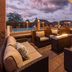 Kokopelli Inn Sedona patio with fire pit, lounge seating and poolside view at dusk