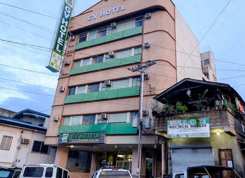 GV Hotel - Pagadian exterior on a city street with green balconies and vertical hotel sign