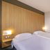 B&B HOTEL La Rochelle Centre guest room with twin beds and wood headboard in La Rochelle