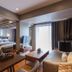 Marine Beach Hotel Pattaya in Jomtien: spacious suite with bedroom, living area, and balcony doors