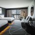 Hôtel Lac Carling Golf & Spa guest room in Grenville with two beds, sofa, desk and balcony doors
