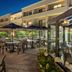 Courtyard by Marriott Chicago Waukegan/Gurnee courtyard patio with tables, umbrellas and evening lighting in Waukegan