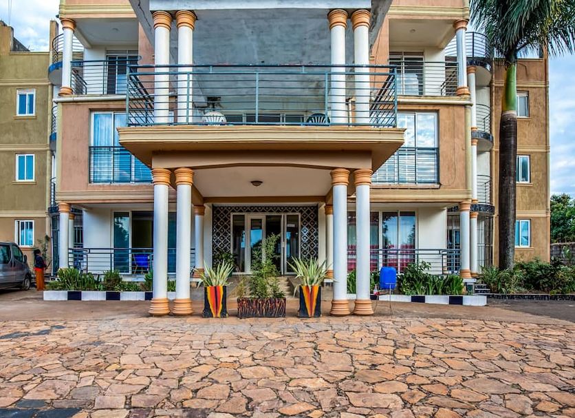 Hotel Royal Nest in Entebbe, exterior entrance with balconies and columns