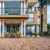 Hotel Royal Nest in Entebbe, exterior entrance with balconies and columns