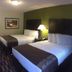Boarders Inn & Suites by Cobblestone Hotels - Ashland City room with two double beds and bedside lamp