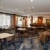 Fairfield Inn & Suites by Marriott Lewisburg breakfast area with tables, chairs and a bar-style counter