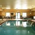 Hampton Inn & Suites Buffalo indoor pool room with lounge chairs and hot tub in Buffalo