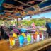 Castle @ Waikiki Grand bar with colorful drinks and surfboards, overlooking Waikiki, Honolulu
