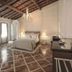 The Stay Galata in Istanbul: elegant guest room with chandelier, tiled floor, and wood-beam ceiling
