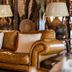 Karongwe - Chisomo Safari Camp in Metz: leather sofa with lamps in a cozy lounge