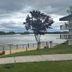 Super 8 by Wyndham Riverside AL waterfront view with dock, tree, and river beside the hotel