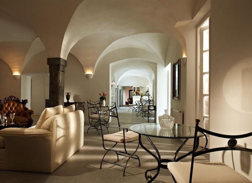 Antiq Palace in Ljubljana historic lounge with arched ceilings, cream sofas and glass tables