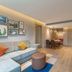 Home2 Suites by Hilton Xishuangbanna Jinghong living room with sofa, dining table and TV