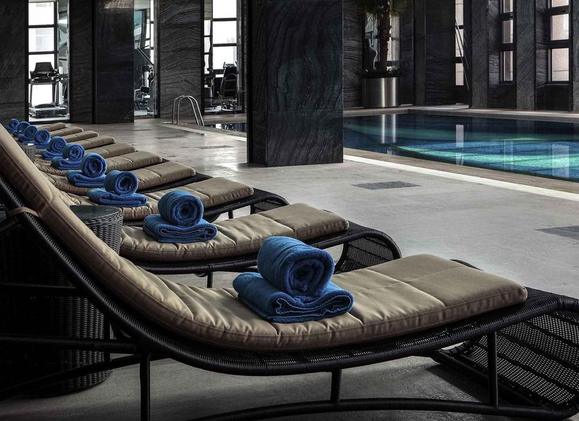 Pullman Anshan Time Square indoor pool with lounge chairs and rolled blue towels
