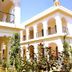 Raj Palace Resort in Sawāi Madhopur with white arched balconies and lush tropical gardens