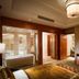 Guanyuan Liusu Hotel Suzhou suite with bathroom, sofa, and TV in warm wood-paneled room