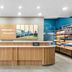 Hampton Inn & Suites Fort Worth/Forest Hill lobby front desk with Hampton welcome sign and snack display