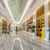 Huiwen Hotel in Shijiazhuang lobby with polished marble floor, gold accents, and plant decor