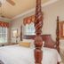 The Beaufort Inn room in Beaufort with a four-poster bed, wood floors, and three windows