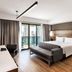 Melia Ibirapuera in Sao Paulo guest room with king bed, sofa, desk and balcony city view