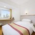 Dalian Jinbai International Hotel guest room with city view through a large window in Dalian