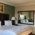 Hampshire Hotel - Ballito guest room with king bed, bedside lamps and wall mirror in Ballito
