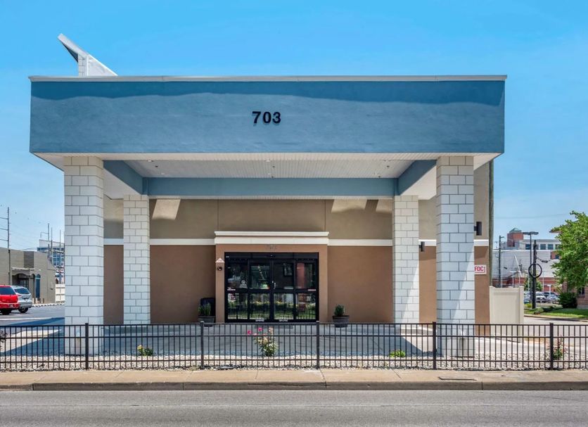 Spark By Hilton Evansville Downtown entrance with blue awning and address 703 in Evansville