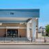 Spark By Hilton Evansville Downtown entrance with blue awning and address 703 in Evansville