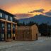 Gravity Haus Revelstoke hotel exterior at sunset with mountain backdrop in Revelstoke