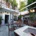 Pension Aduar in Marbella courtyard with tiled tables, wrought-iron chairs, and potted plants