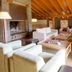 Reserva del Saja Hotel & Spa lounge with stone fireplace and wooden-beamed ceiling in Renedo de Cabuérniga