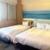 Richmond Hotel Miyazaki Ekimae guest room with two beds and ocean-inspired wall art in Miyazaki