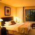Zawadi House Arusha guest room with bed, desk, wall-mounted TV and window view