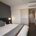 Dormy Inn Premium Shimonoseki Natural Hot Spring guest room with bed, desk, and air conditioner