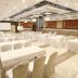 The Grand Radiant Hotel Lucknow banquet hall with white-clothed tables and chairs