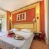 Club Belambra Le Vidourle room with double bed and patio door to a garden terrace in Le Grau-du-Roi