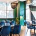 Novotel Melbourne Glen Waverley dining area with blue chairs and large windows in Glen Waverley