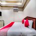 Hotel Ik London Residency in Hyderabad room with bed, wall AC, and gold-trimmed ceiling