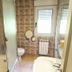 Arena Surf Hotel in Somo bathroom with shower, bathtub, toilet, and tiled walls