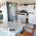 Il Camaleonte dal 2005 in Bracciano: compact kitchen with refrigerator, sink, cabinets and dining table