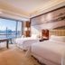 The Westin Wuhan Wuchang guest room with twin beds and city skyline view in Wuhan