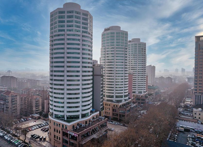 Huangpu Hotel in Nanjing with three tall cylindrical towers and city skyline views