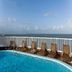 Intercity João Pessoa rooftop pool with lounge chairs and ocean view in João Pessoa
