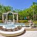 Hampton Inn Palm Beach Gardens courtyard fountain with archway and lush tropical landscaping